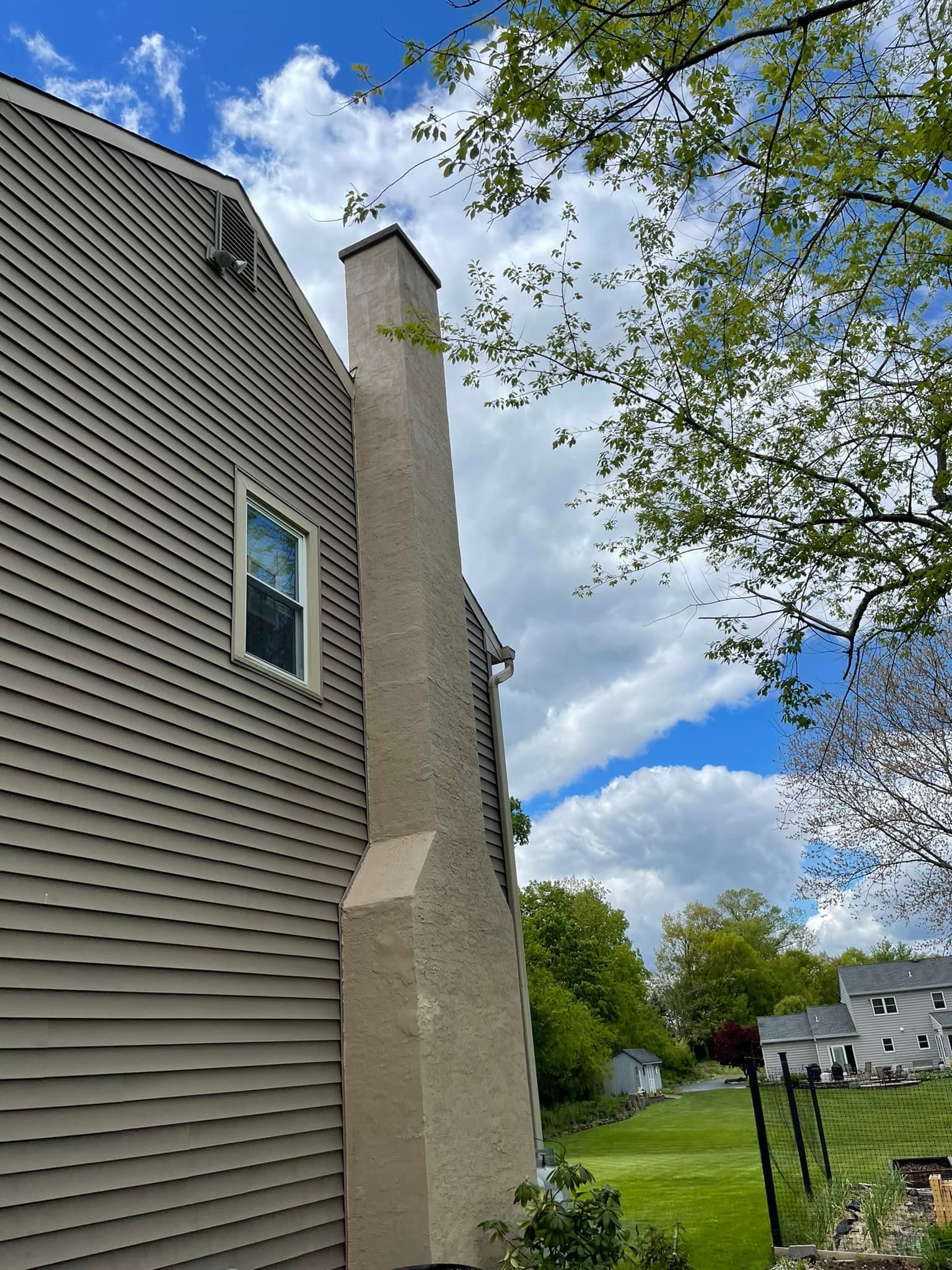 A house with a chimney on the side of it.