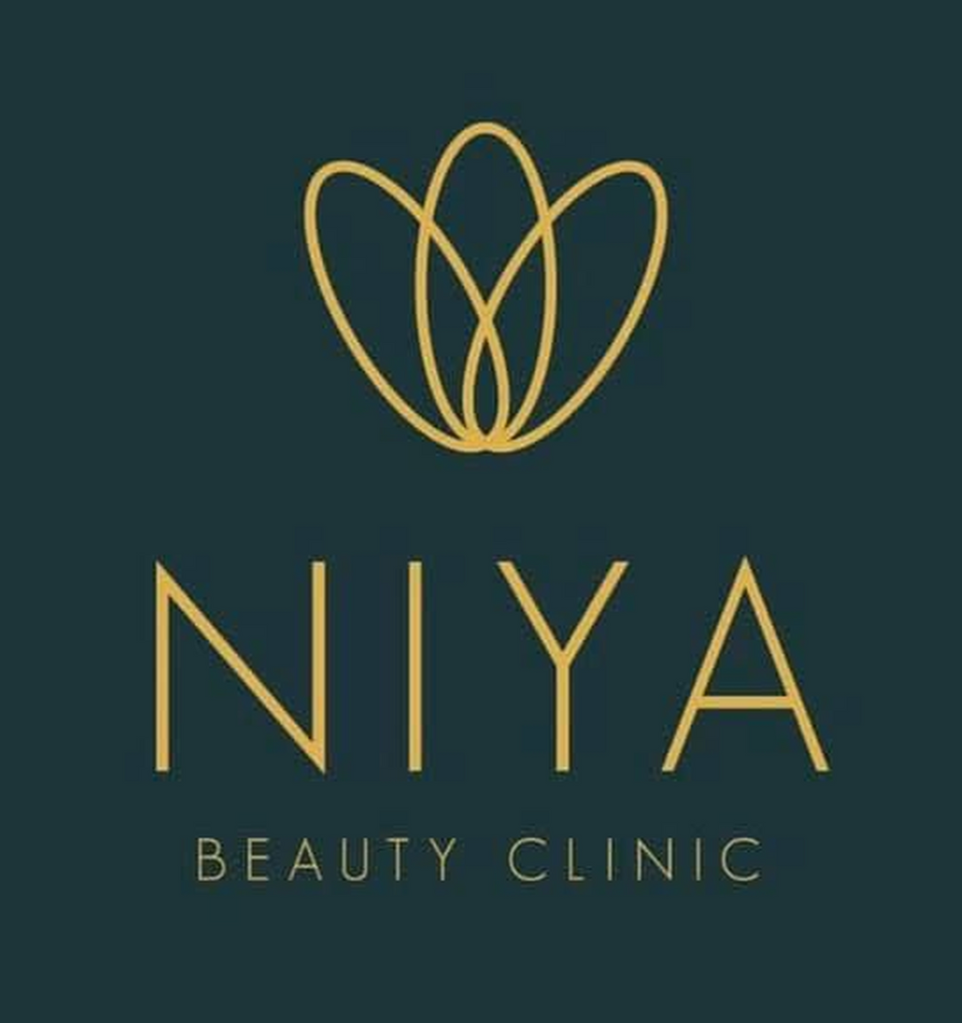 Logo for Niya Beauty Clinic: gold floral design above gold text on a teal background.