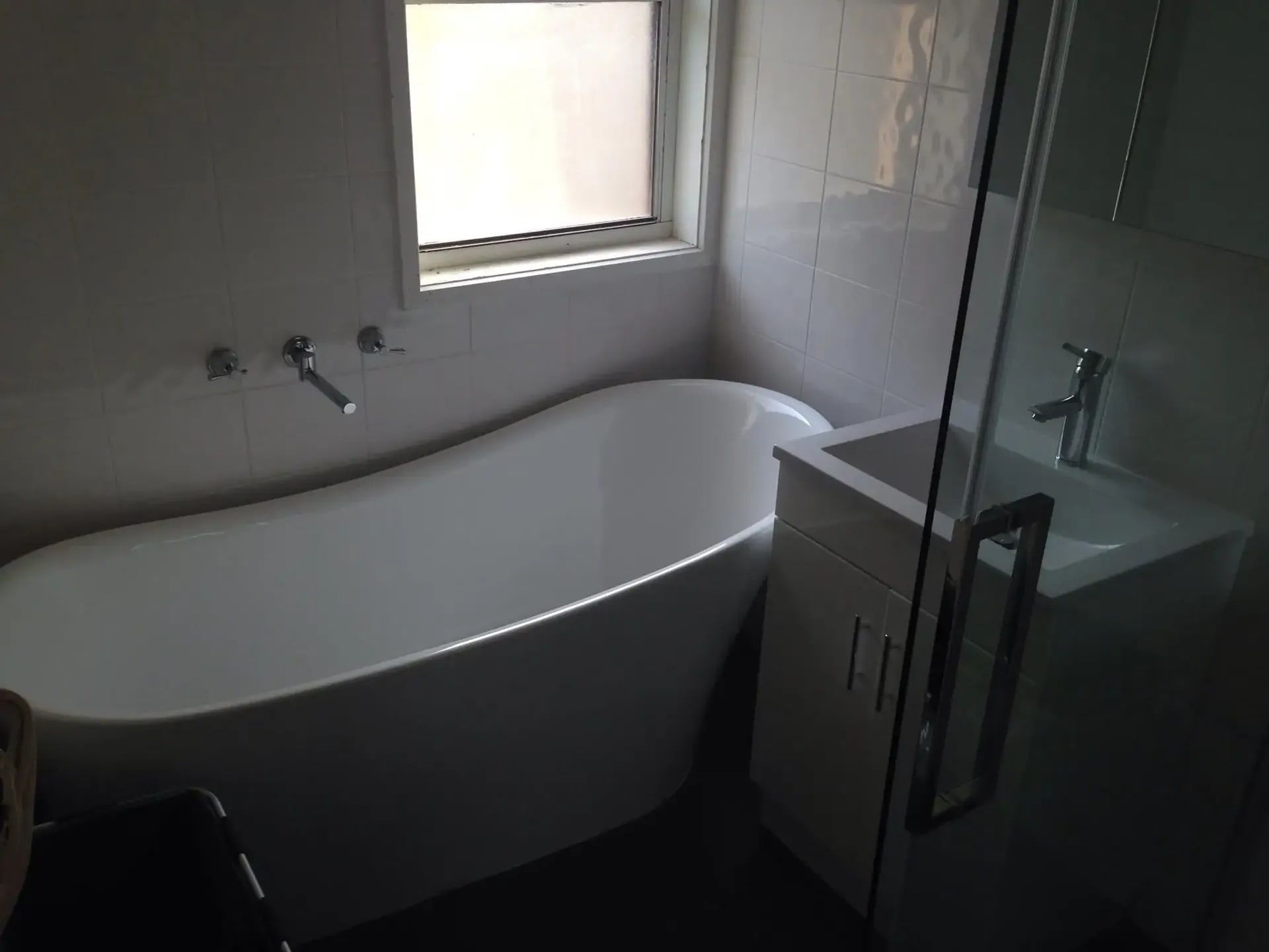 A Bathroom with A Tub, Sink and Window — Blair Merlehan Plumbing in Tumbarumba, NSW
