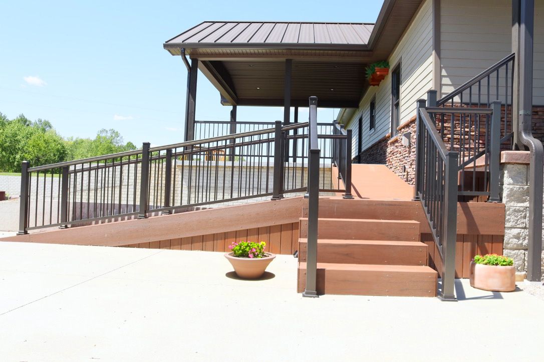Wheelchair ramp and steps leading to wrap-around porch.