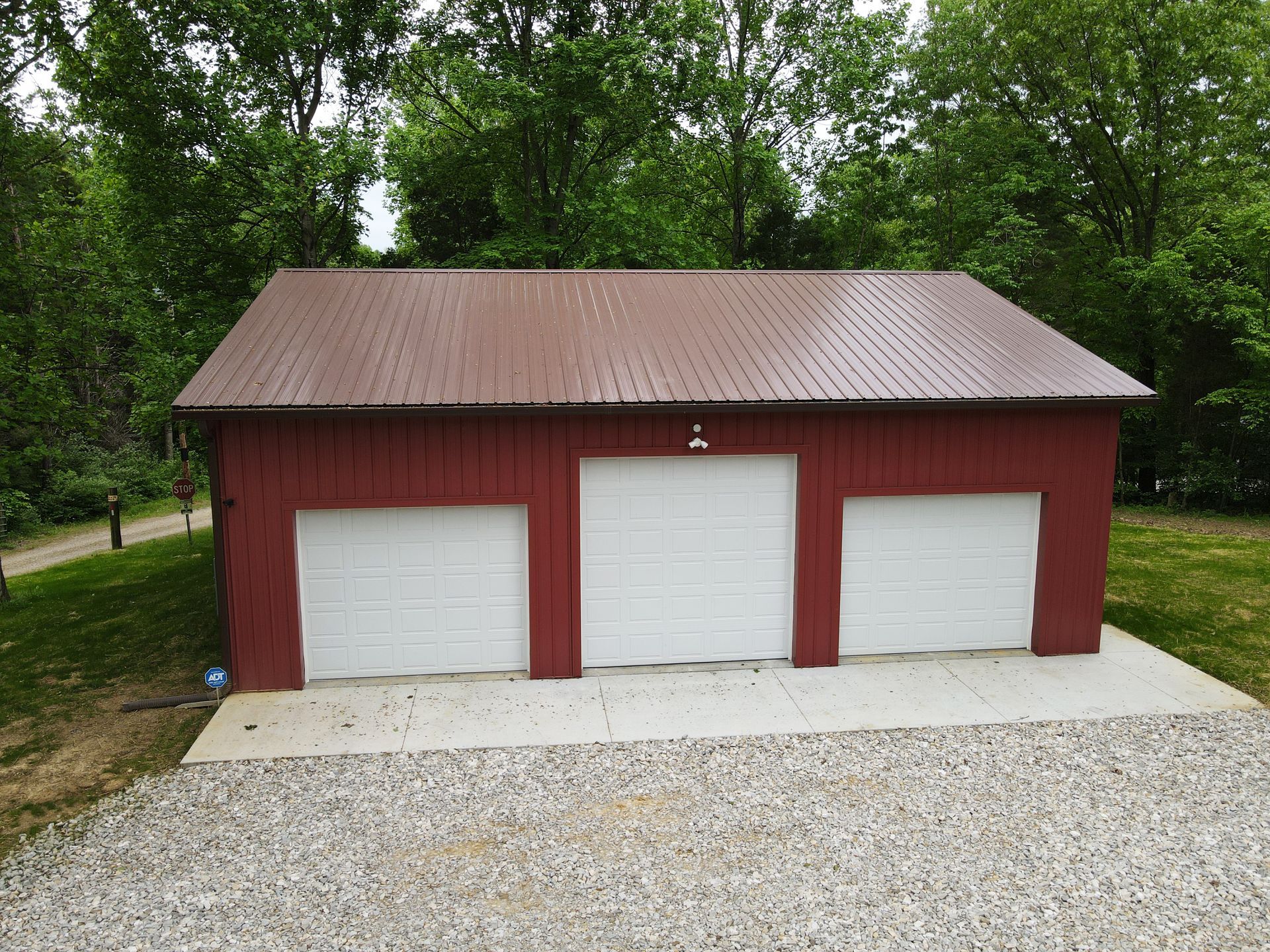 Post Frame Garage. Aggregated metal roof and siding. Colors: Brown, Barn Red, White