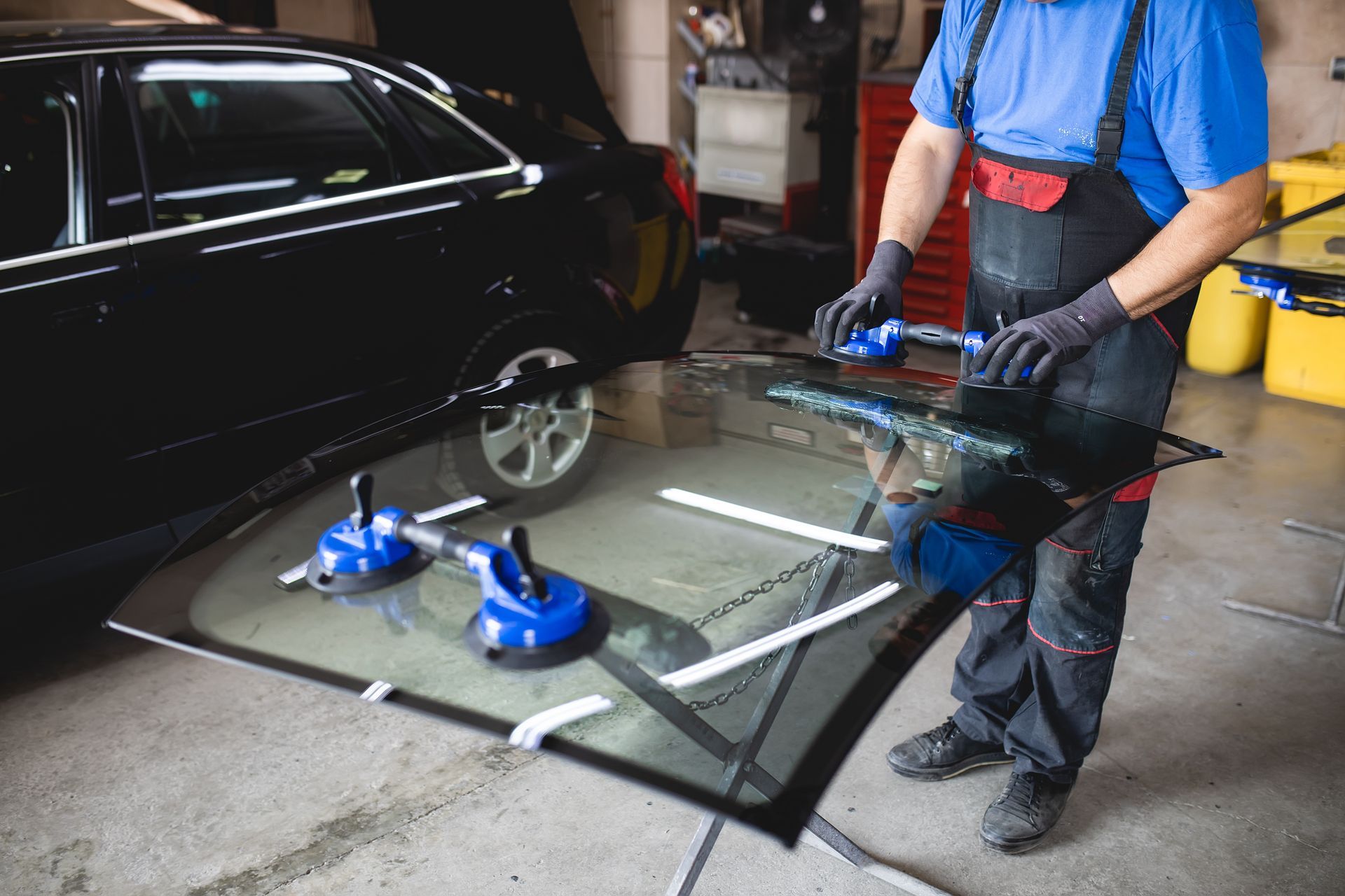 Auto Mechanic Replacing Windshield