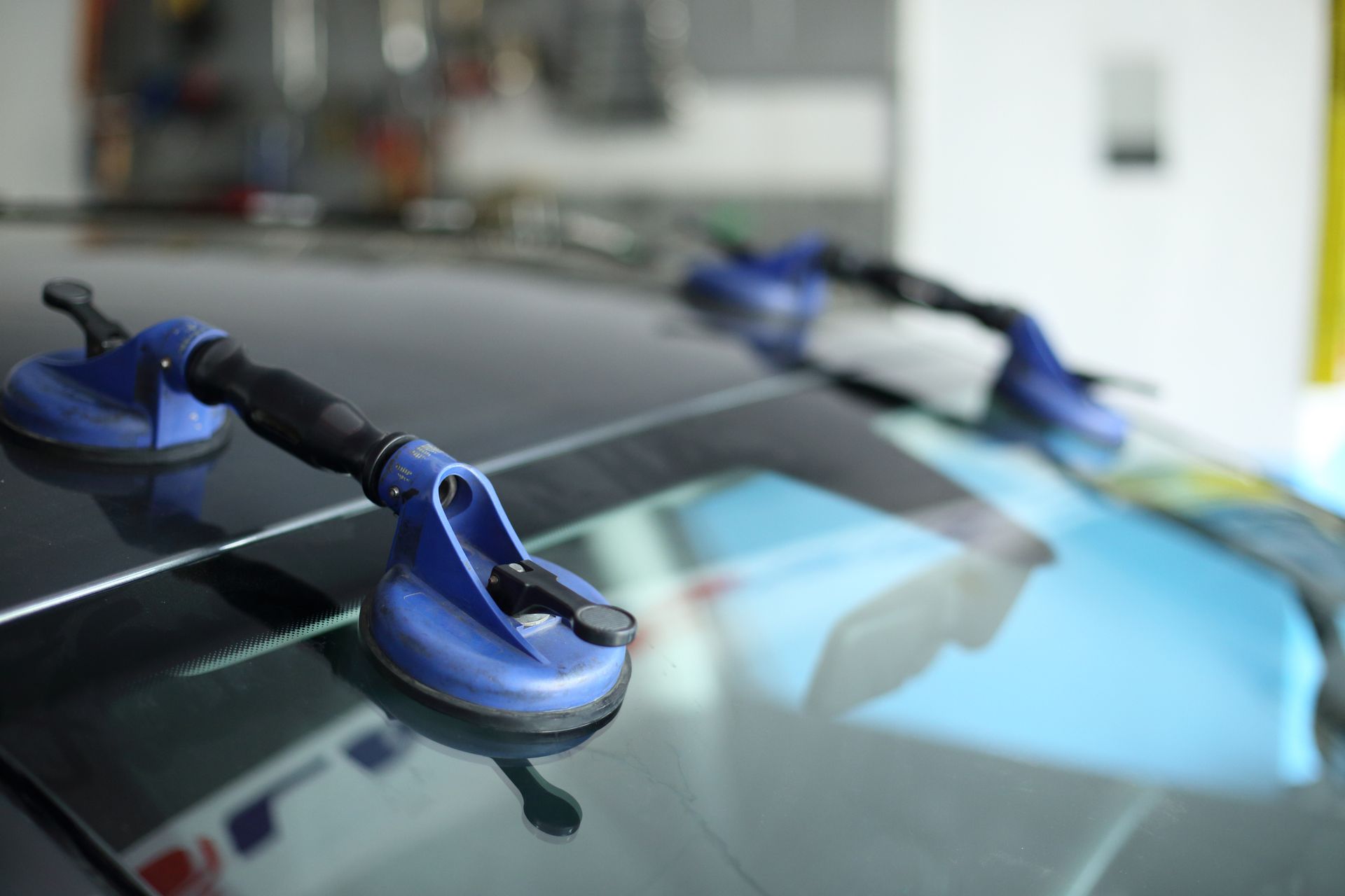 Two Blue Suction Cups On a Car Windshield