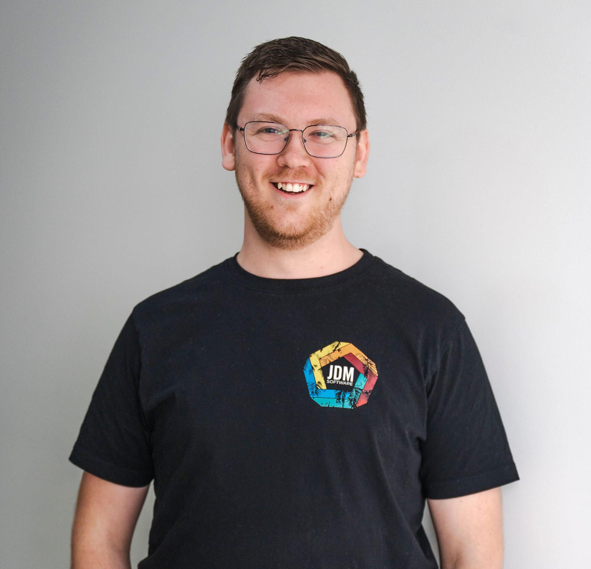 Wade Walsh is wearing a blue shirt and smiling