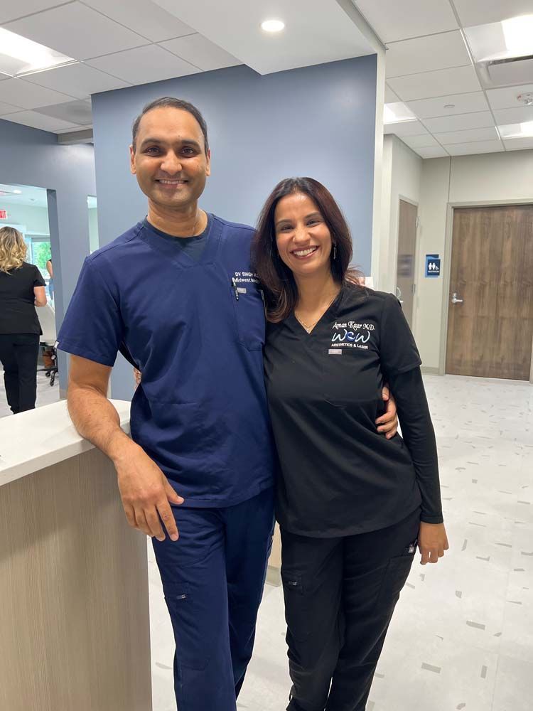 A man and a woman are posing for a picture in a hospital.