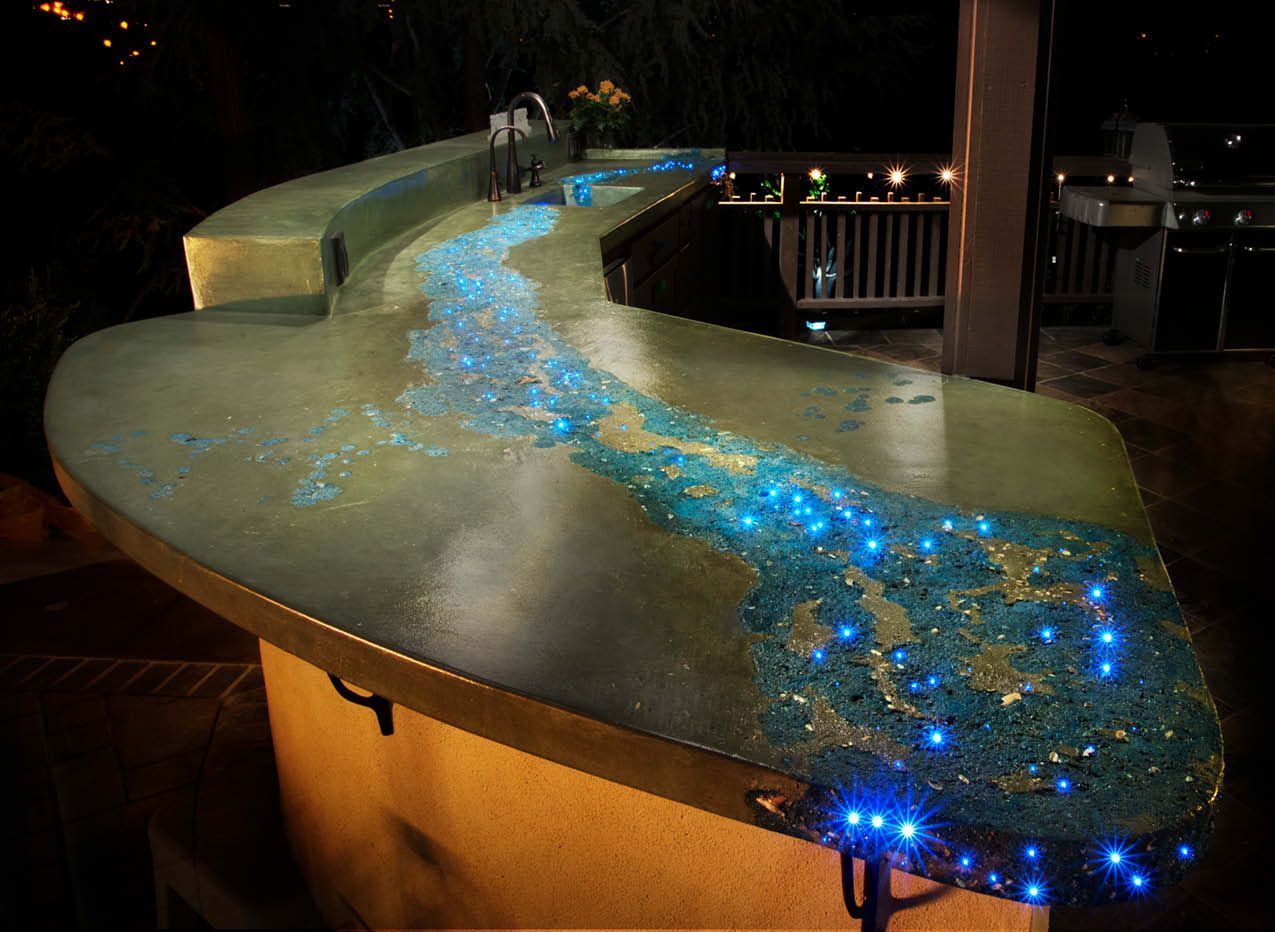 Curved countertop with glowing blue embedded lights in a dimly lit indoor setting