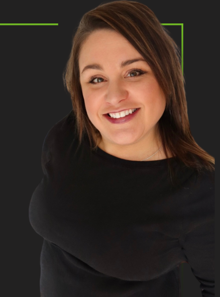 Smiling woman in a black top against a dark background