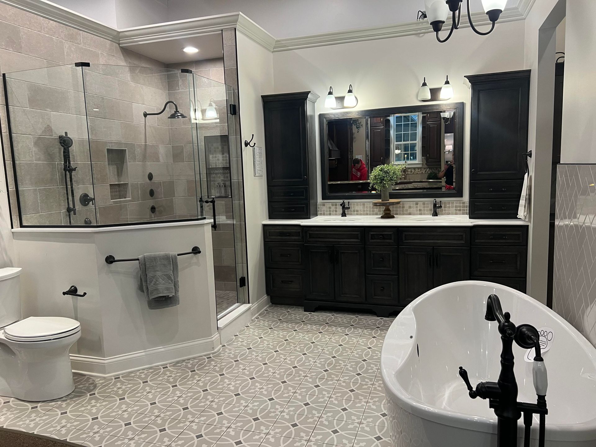 Spacious bathroom with shower, toilet, vanity, and freestanding tub in a light, tiled design