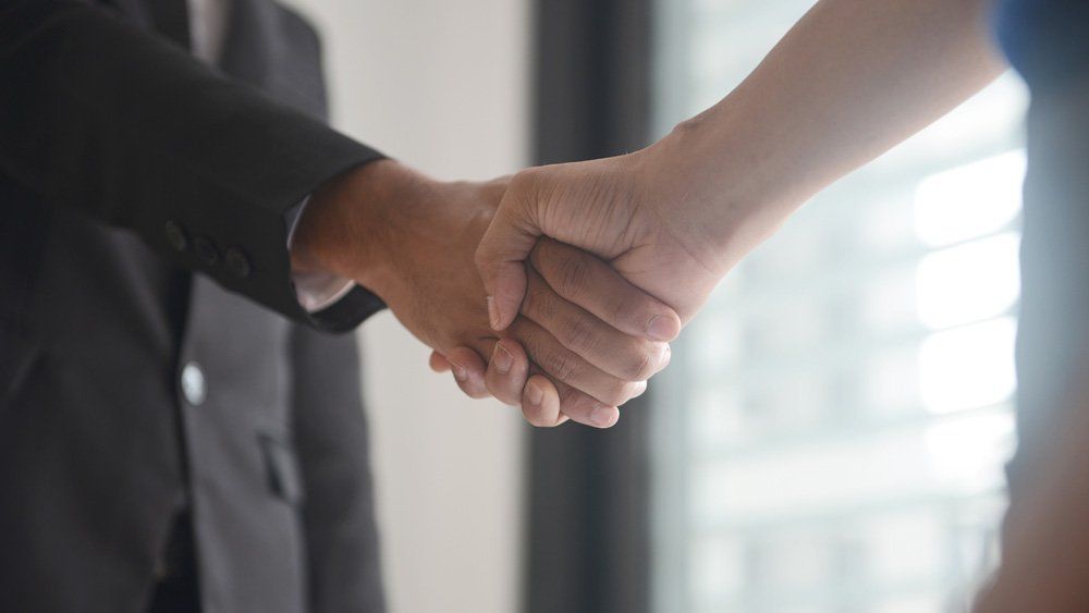 Attorney Shaking Client's Hand — Dos Palos, CA — Linneman Law