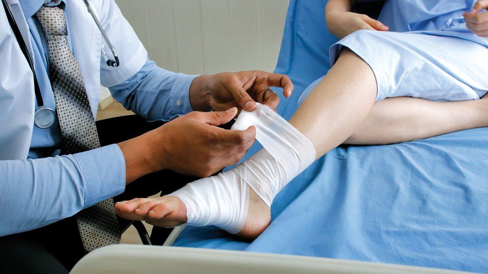 Putting Bandage On Leg — Dos Palos, CA — Linneman Law