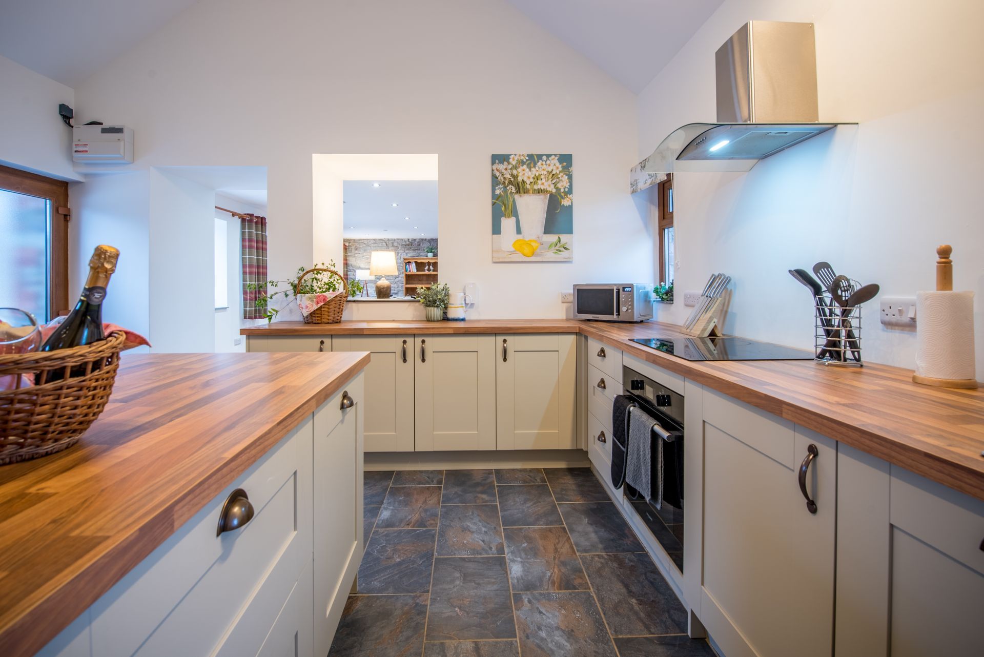 Bright kitchen in The Coach House featuring modern appliances and wooden worktops.
