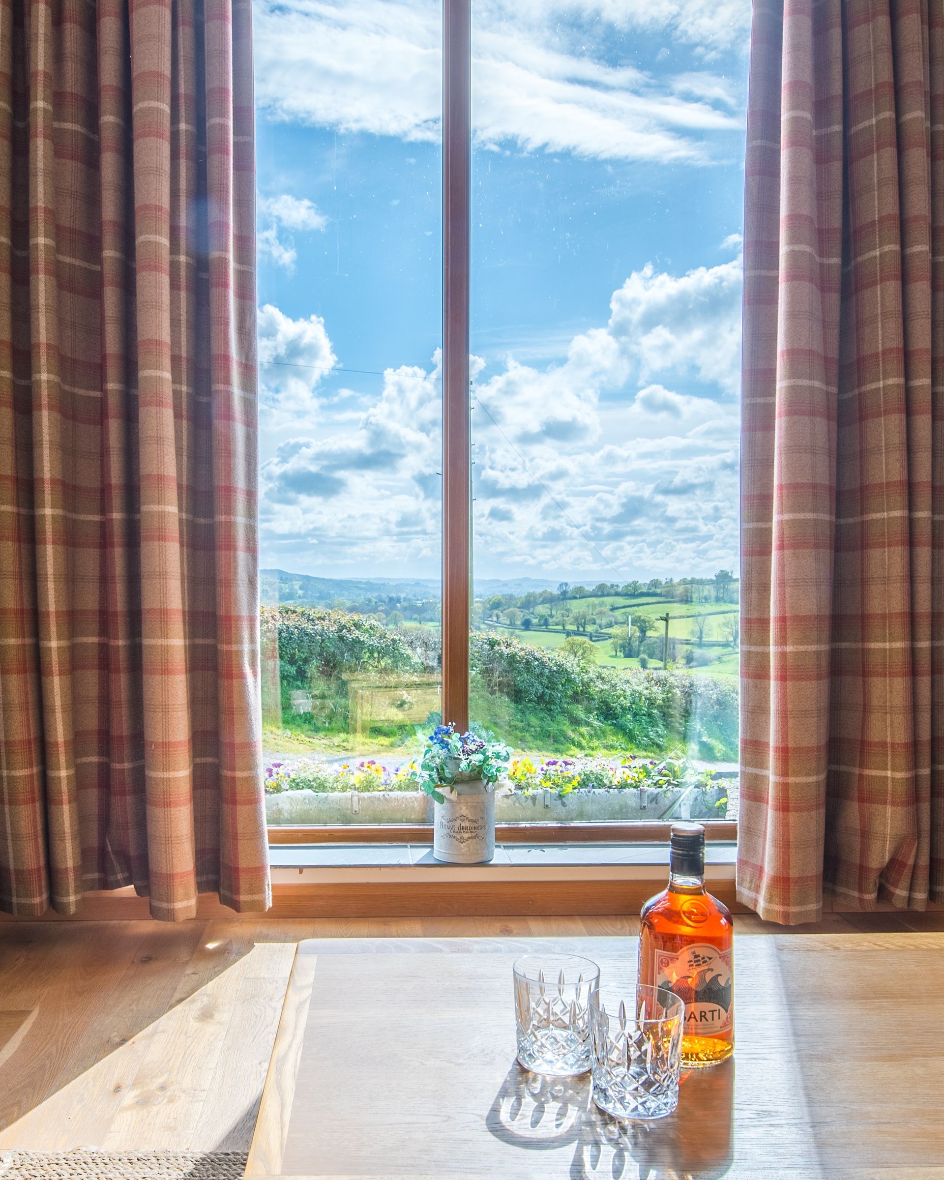 Countryside view through window at The Cowshed holiday cottage, Carmarthenshire.