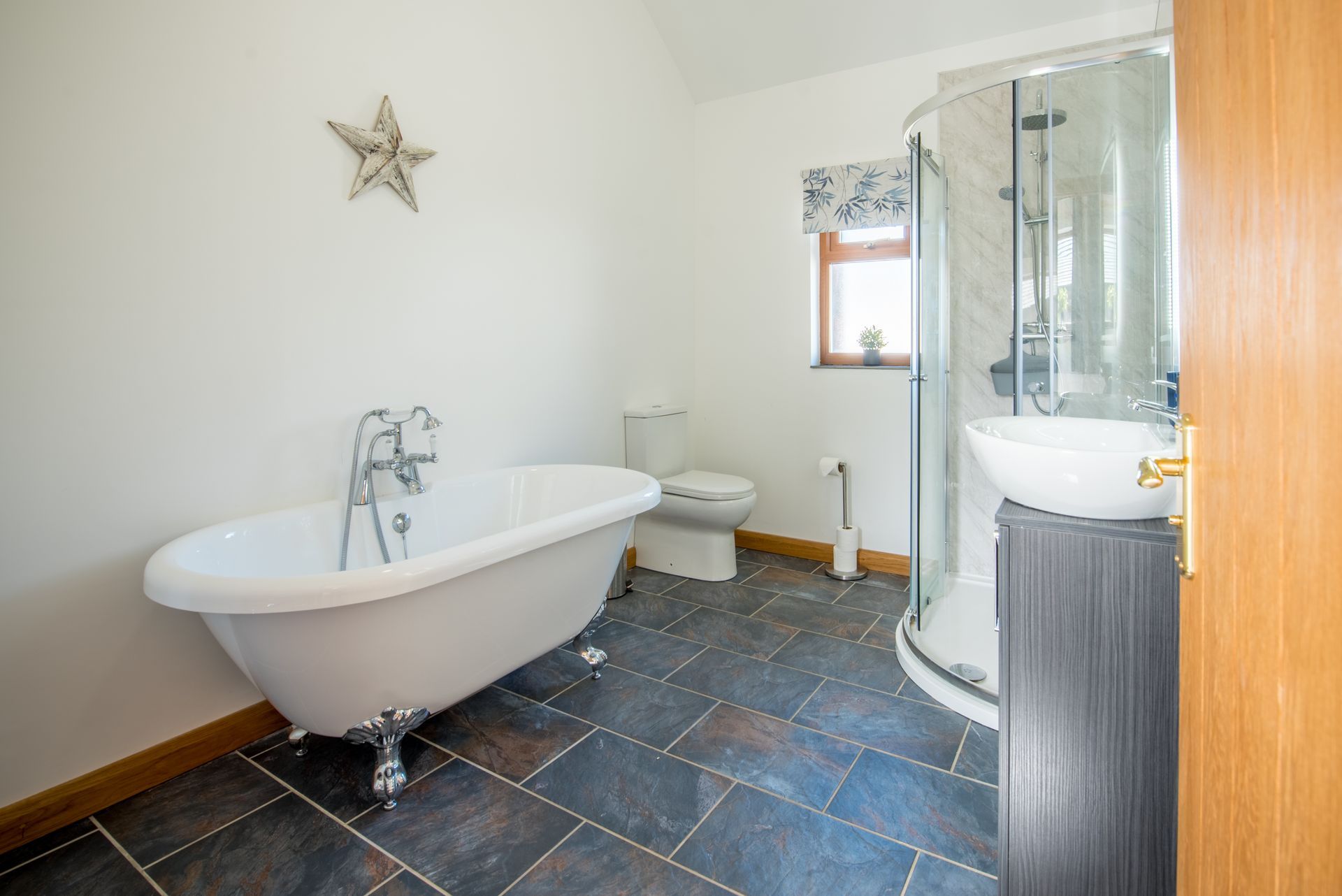 Bathroom at The Coach House featuring freestanding bath and walk-in shower.