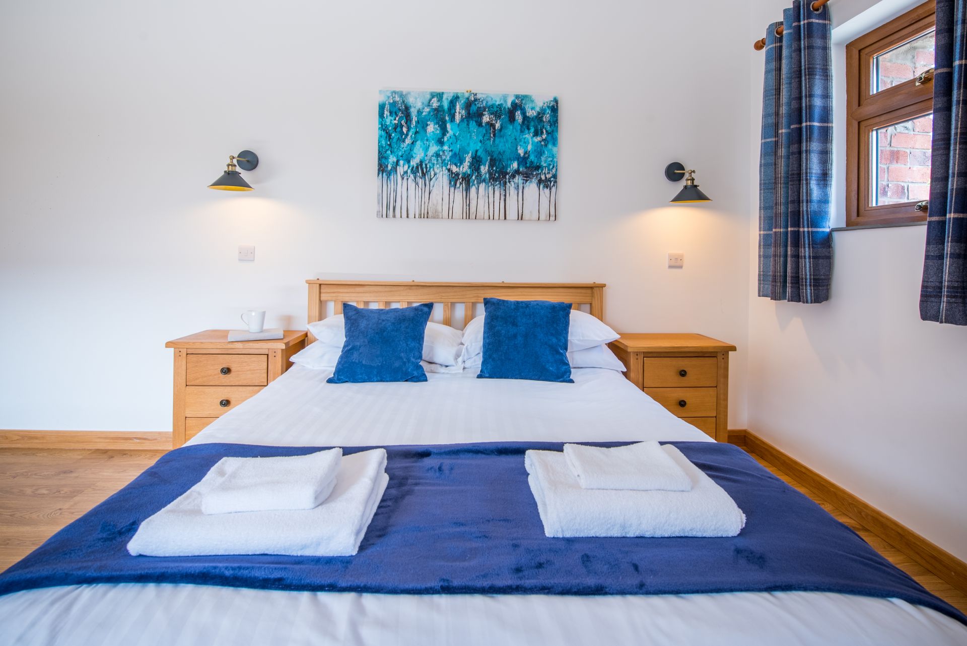 Bright double bedroom with blue accents at The Coach House holiday cottage, Green Grove Barns.
