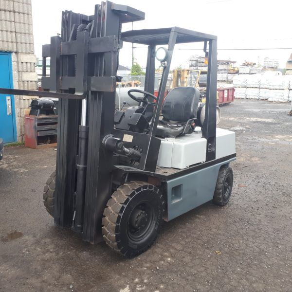 A black and white forklift is parked in a parking lot