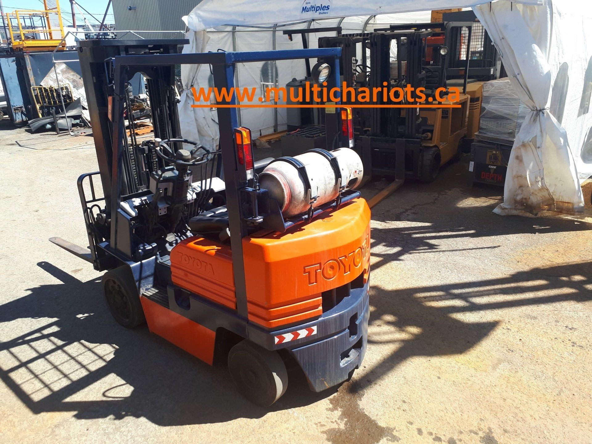 A toyota forklift is parked in a parking lot