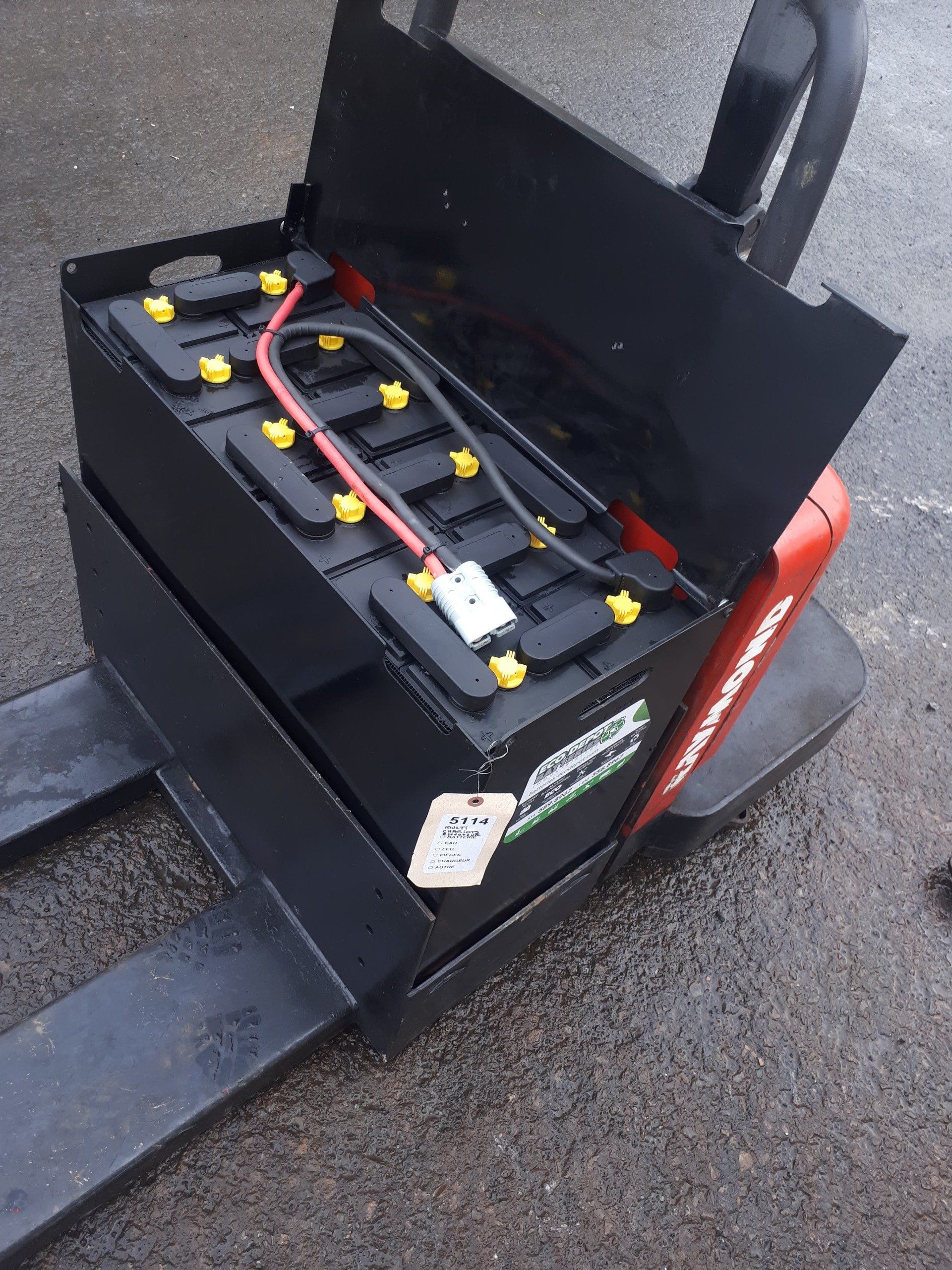 A forklift with a battery sitting on top of it