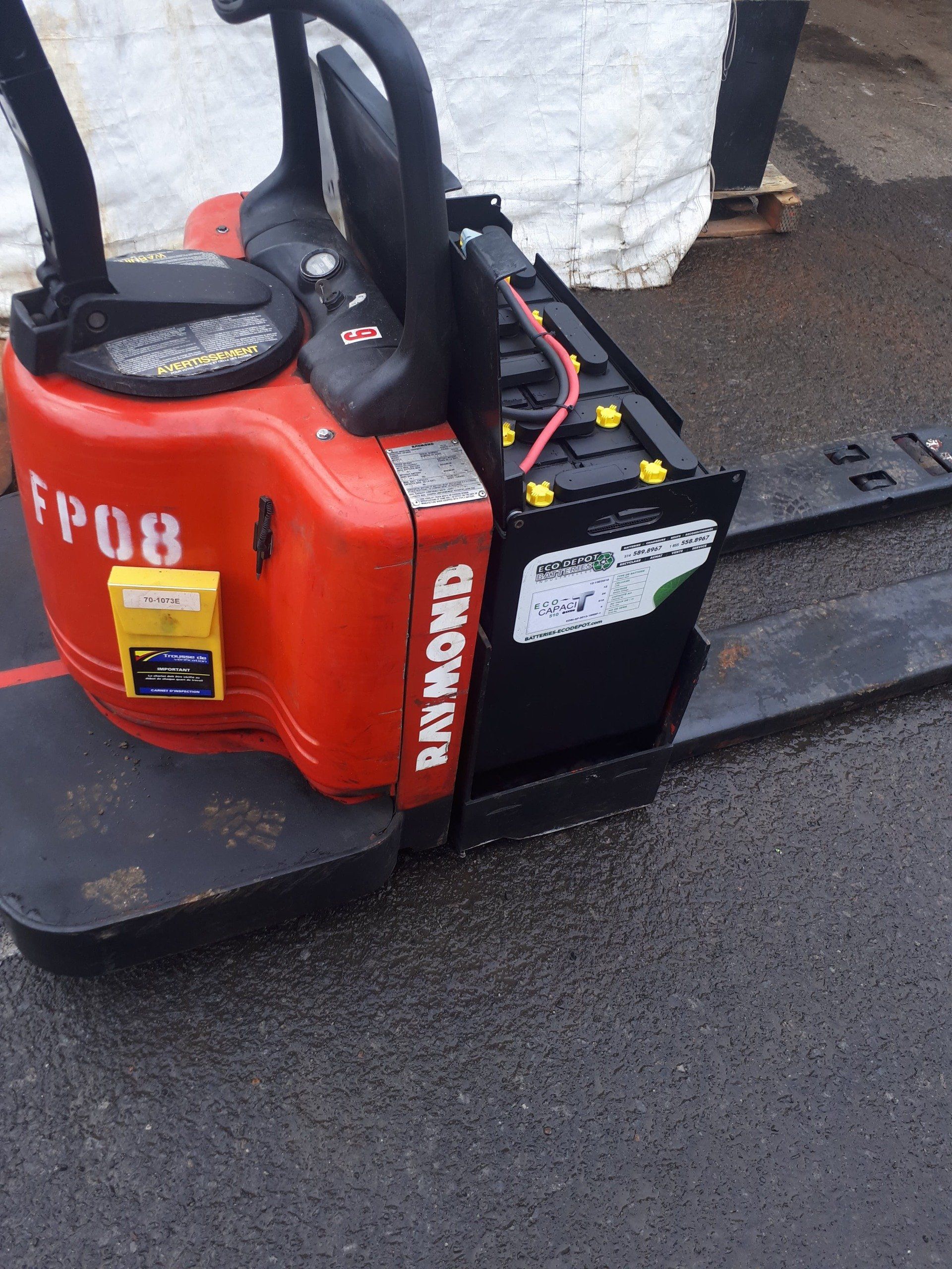 A raymond forklift with a battery attached to it