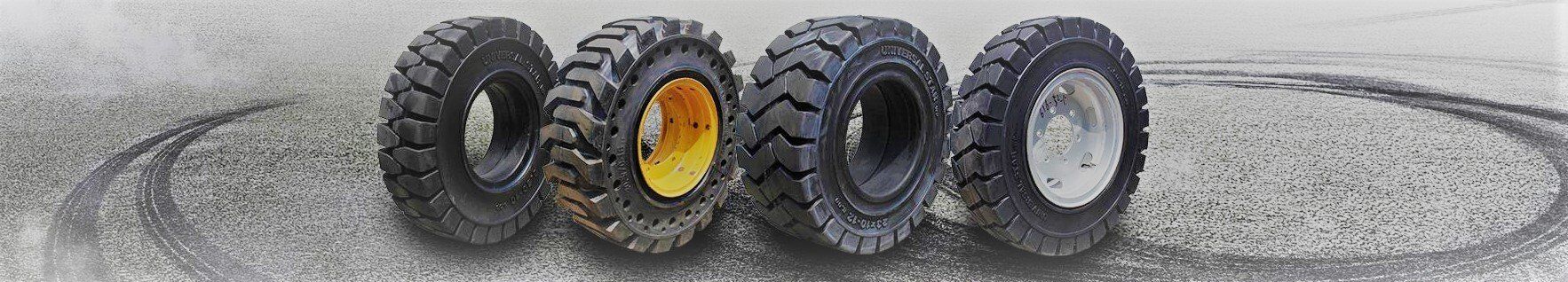 A group of tires are lined up on a road.