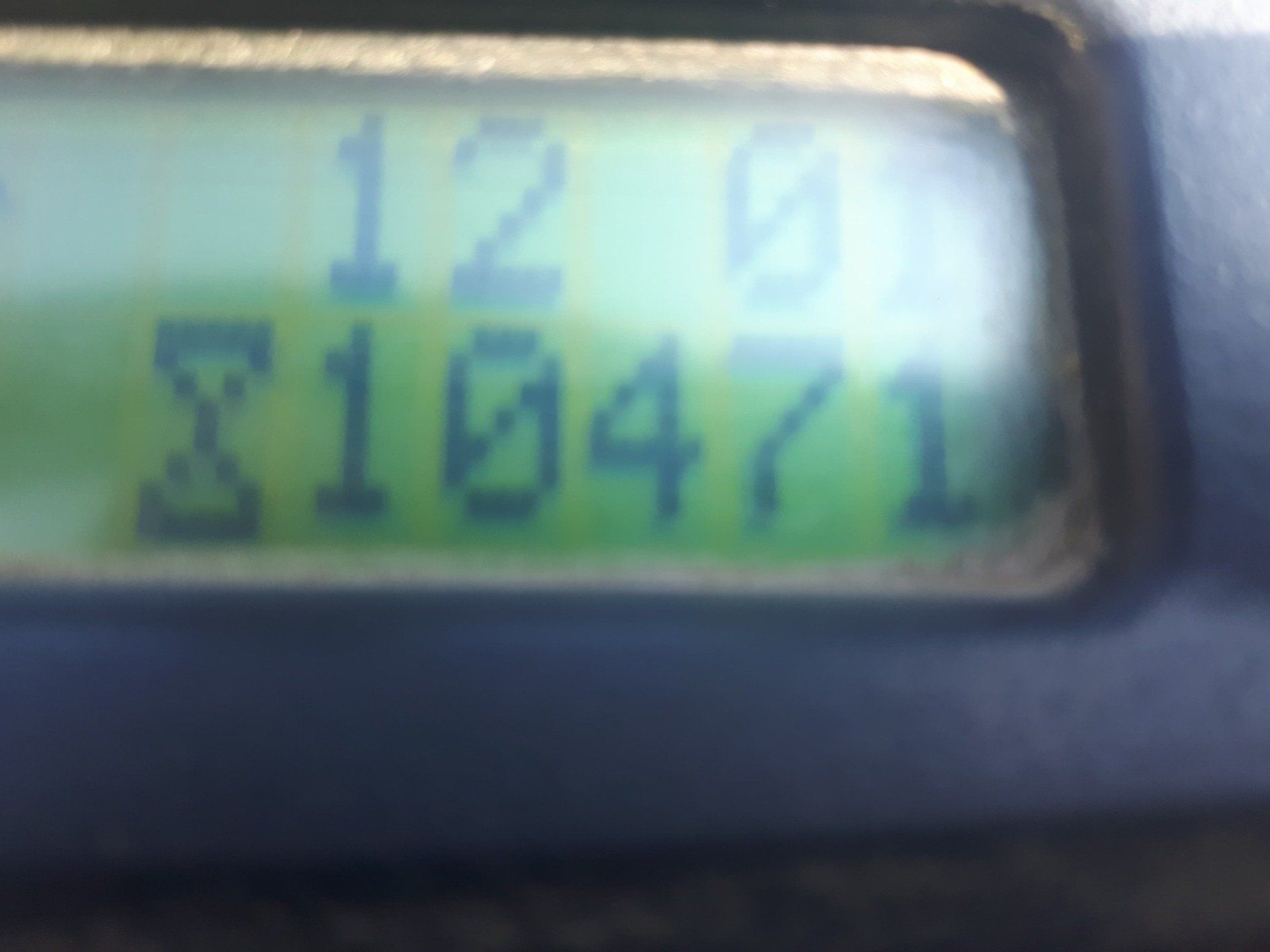A close up of a calculator displaying the number s10471