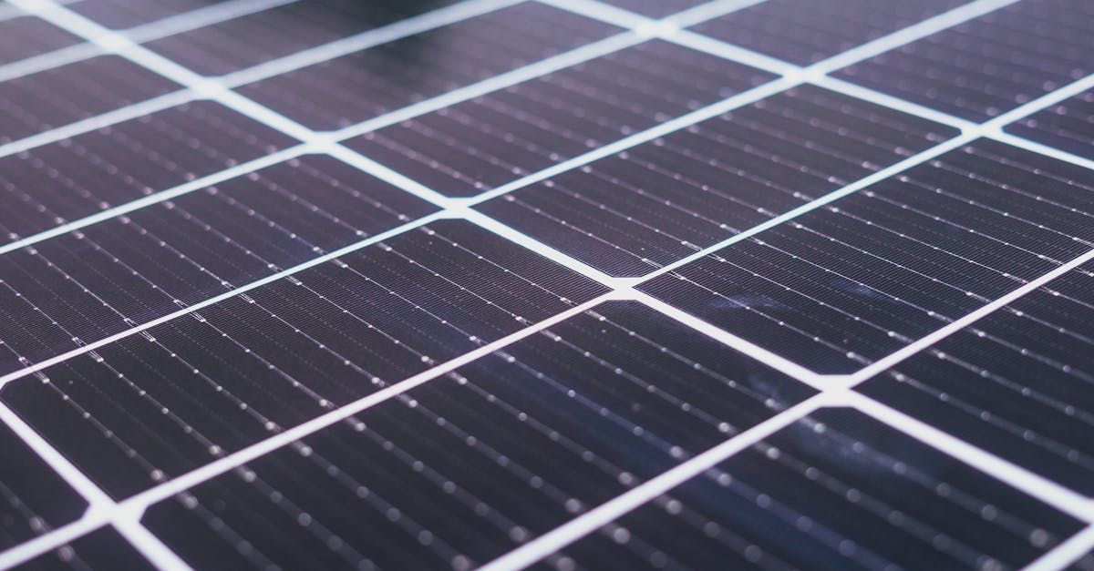 A close up of a row of solar panels on a roof.