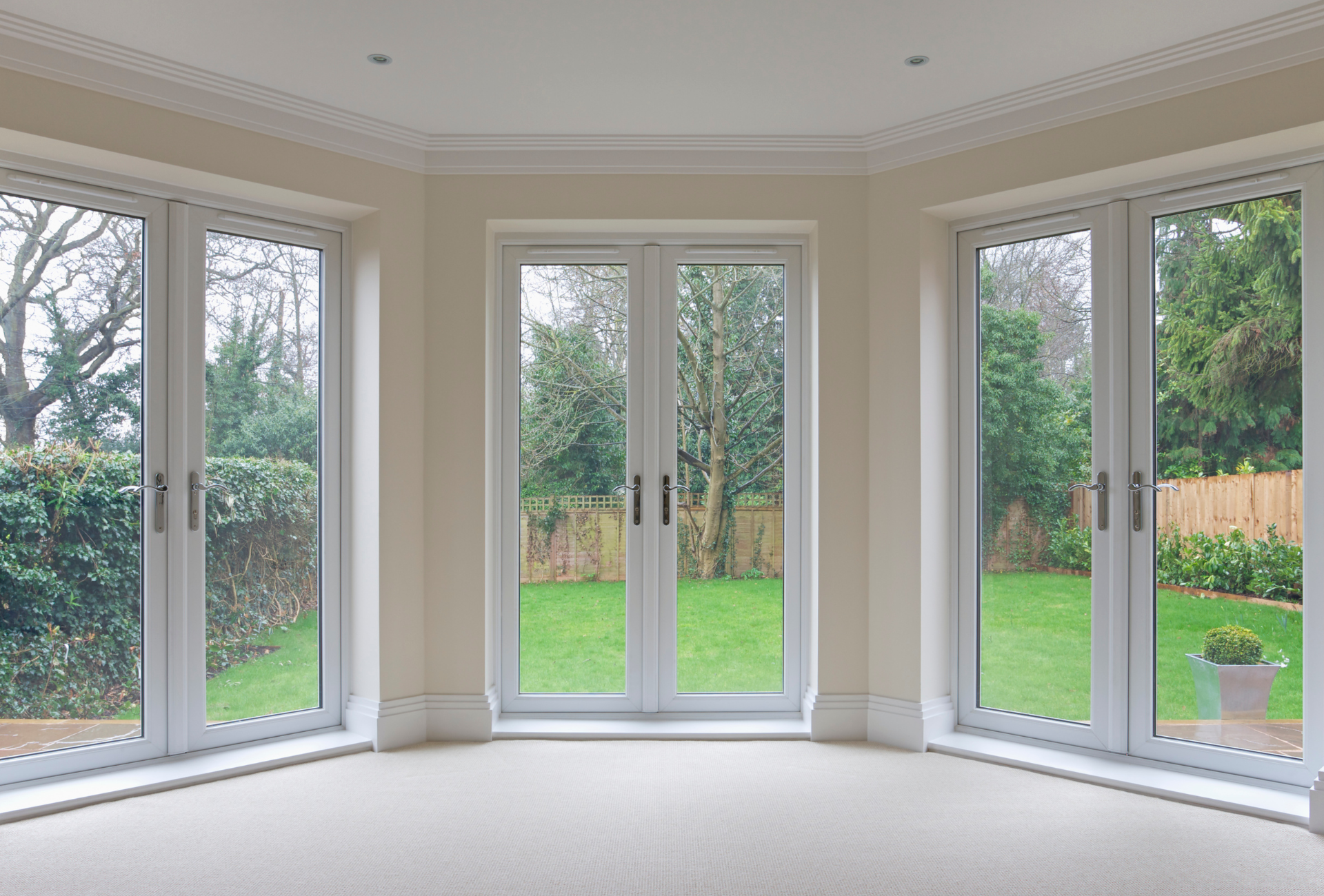 An empty room with a lot of windows and doors