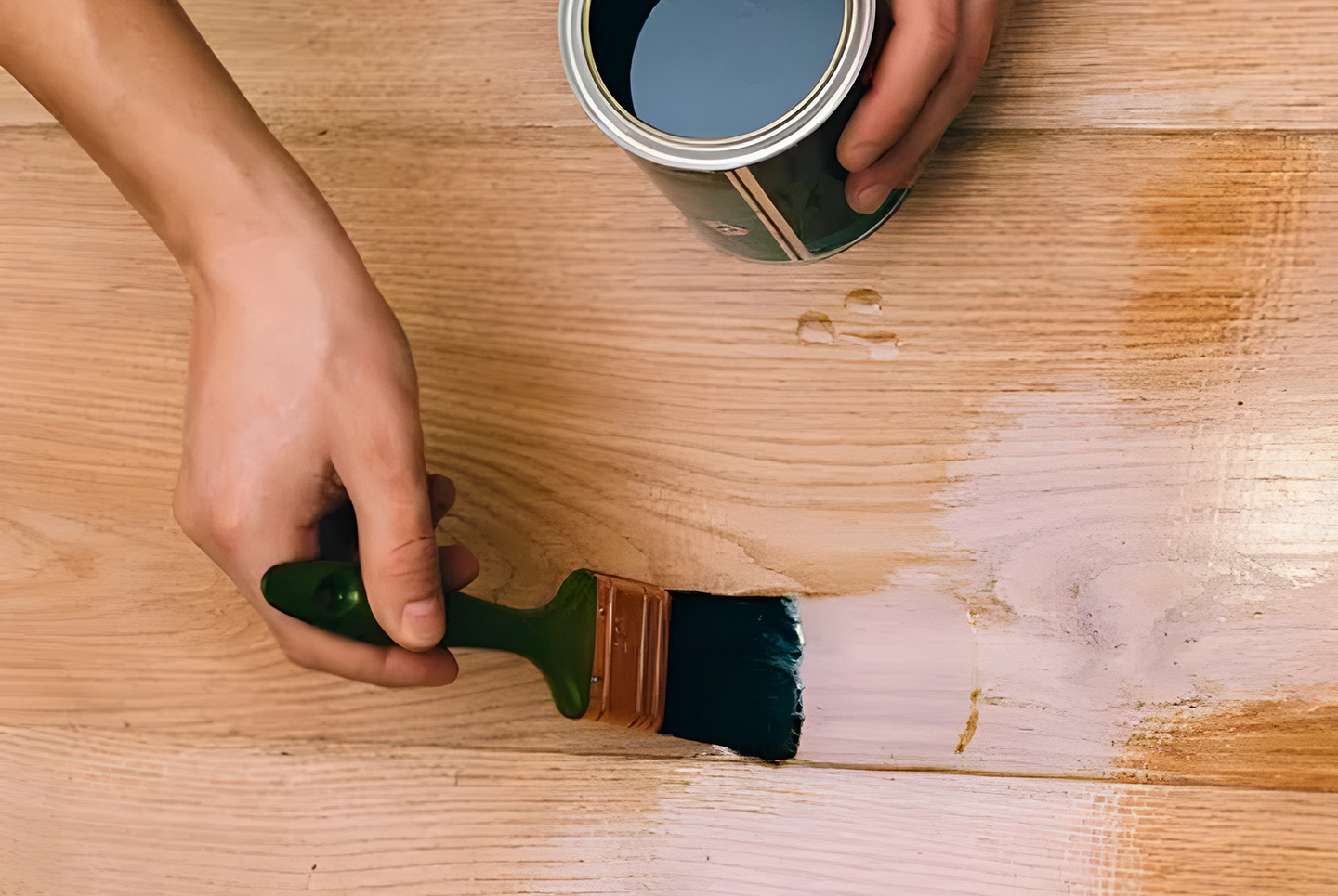 Applying Finish To Timber Kitchen Flooring With Brush And Stain
