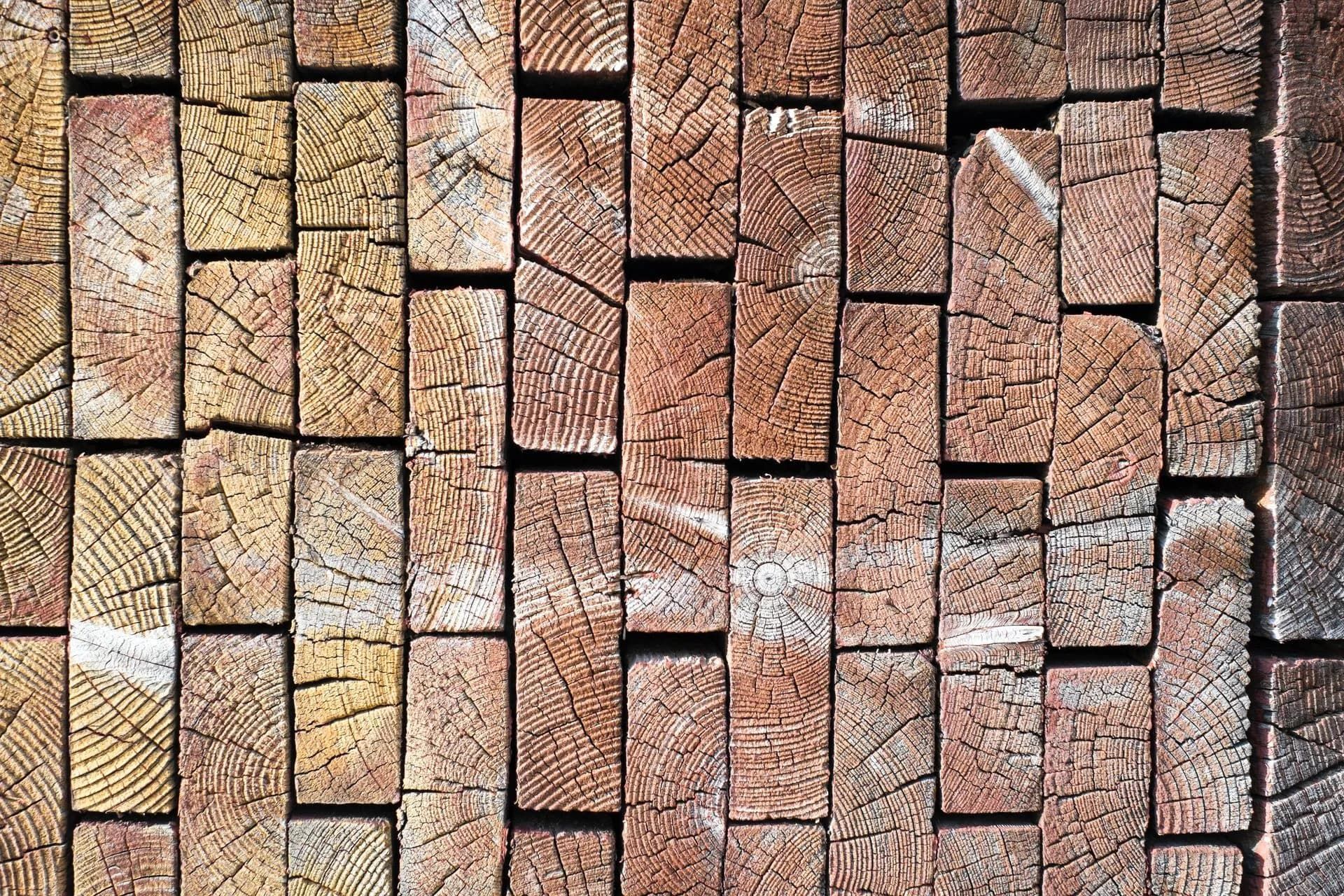 Stacked Wooden Beams, Varying Shades — Sly Bros in Yamba, NSW