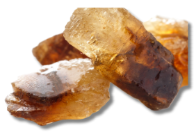A close up of a pile of brown rocks on a white background