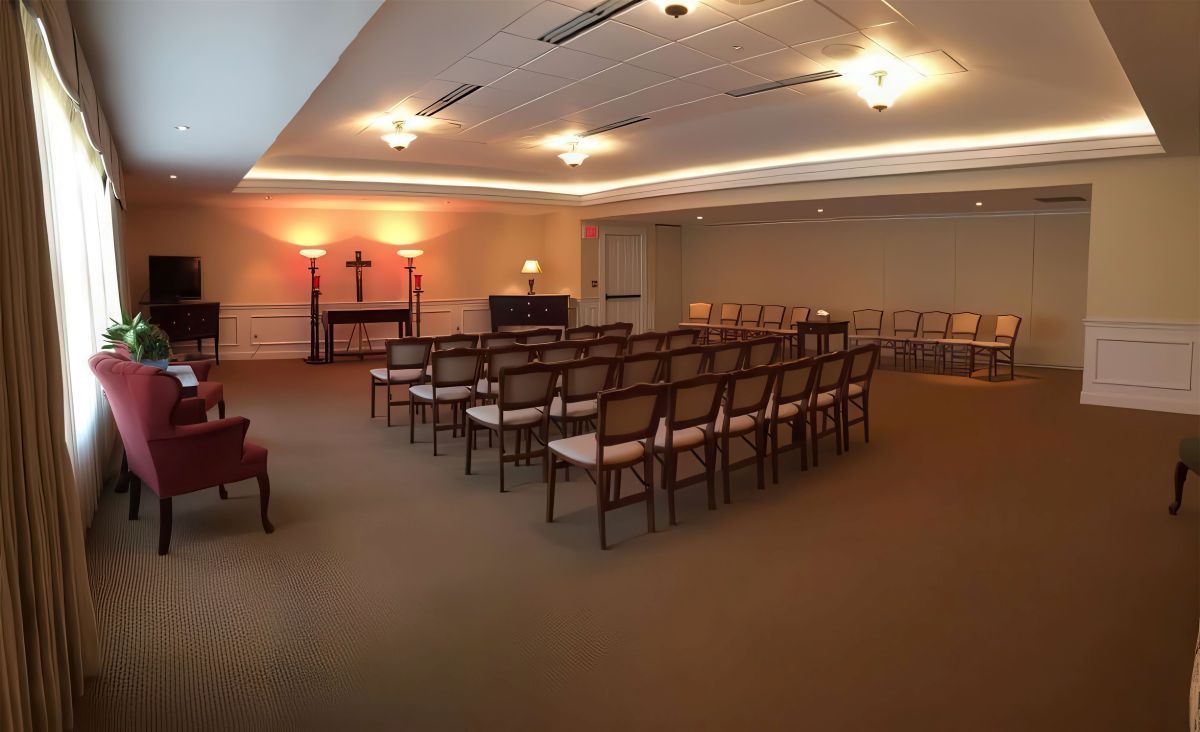 Interior of a funeral home chapel with rows of chairs facing an altar.