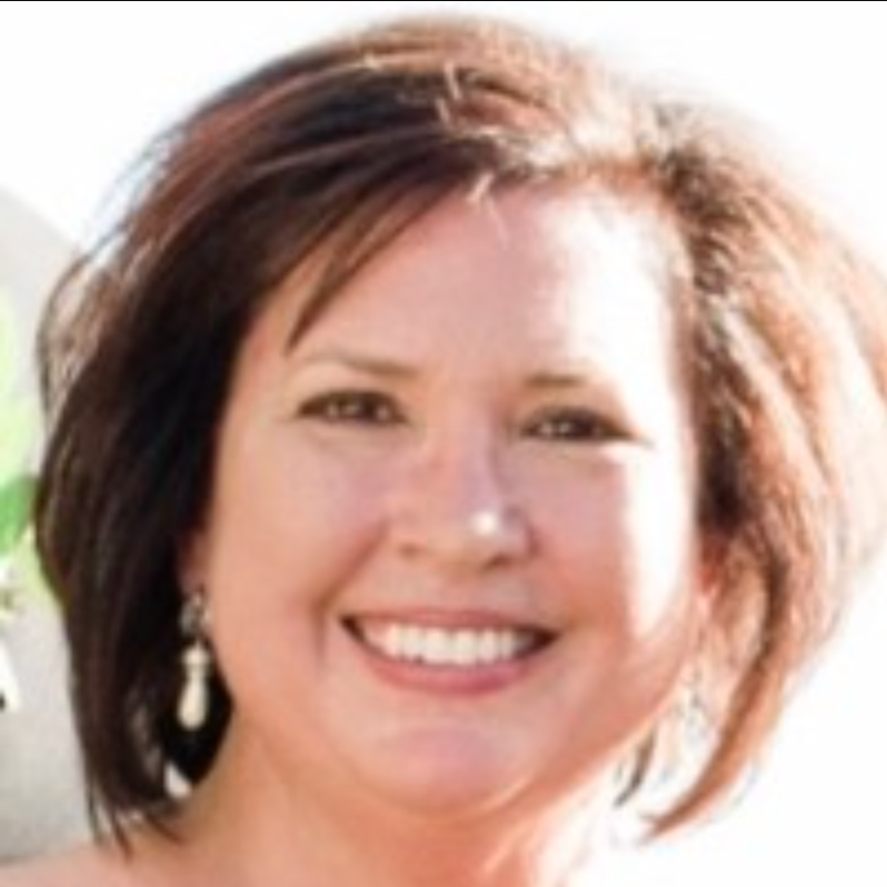 A woman with short brown hair is smiling for the camera