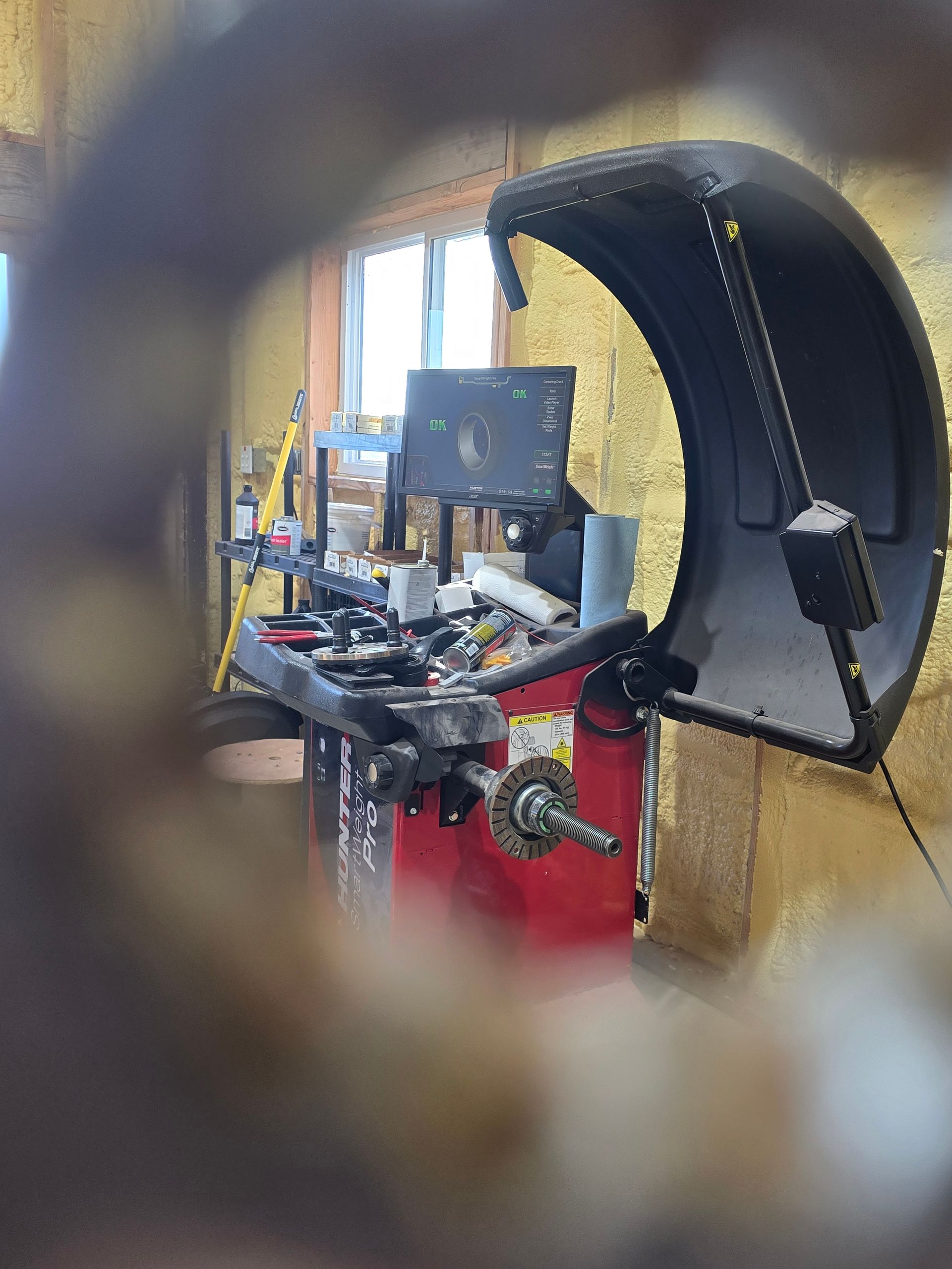 Exercise machine in a gym, viewed through a blurred circular foreground frame.