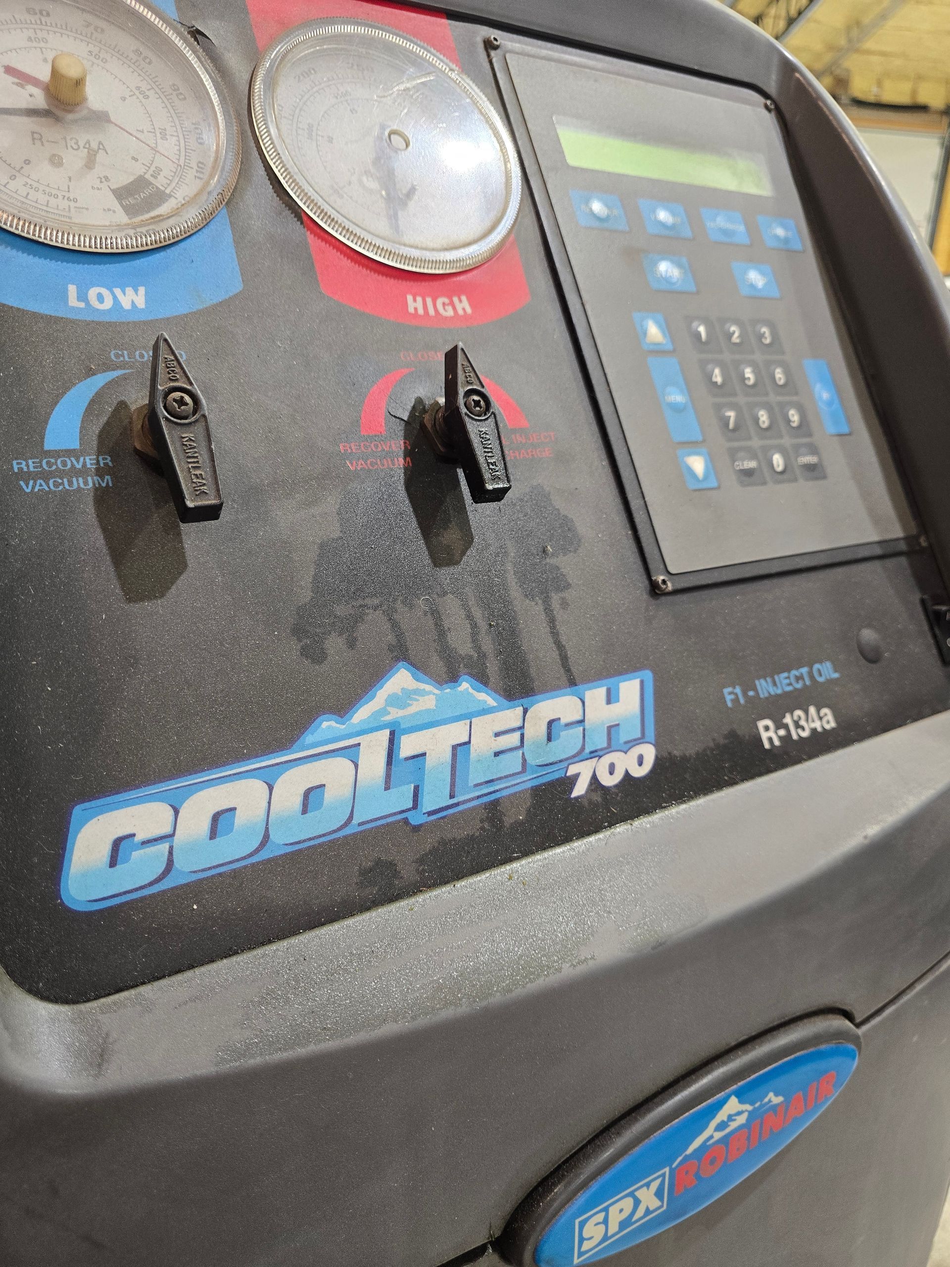 Close-up of a blue and gray Gojo Tech 7000 machine control panel with gauges and buttons