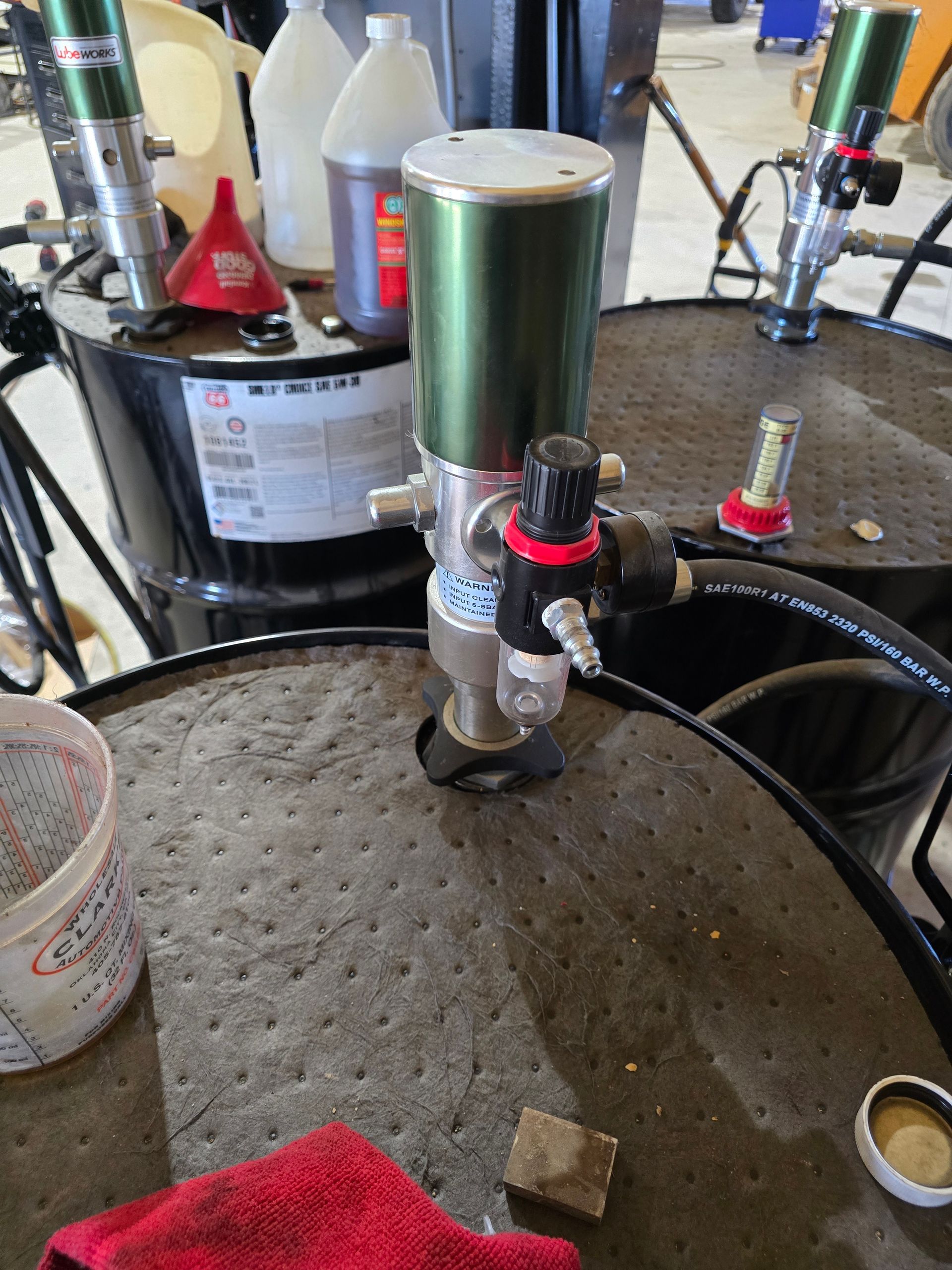 Water filtration equipment and tanks beside a large metal basin in an industrial setting