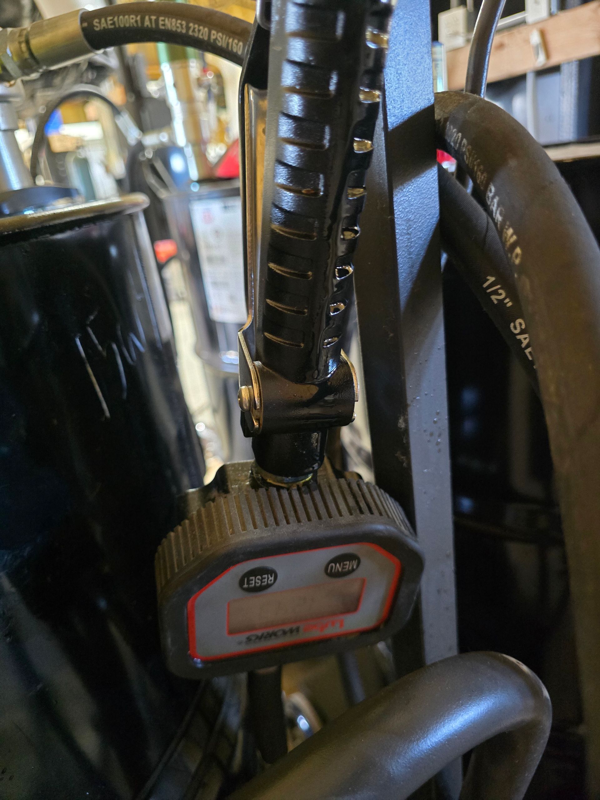 Close-up of a bicycle handlebar with a black light or device mount attached on a crowded background