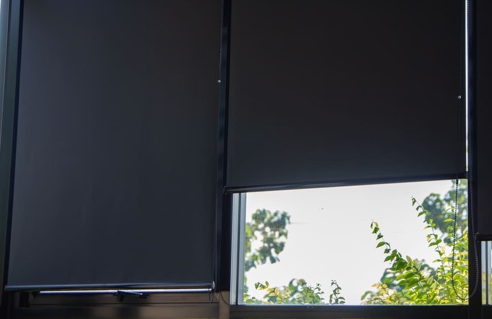 A Close Up Of A Window With Black Blinds On It — Geoff Thompson's Independent Flooring Centre In Port Macquarie, NSW