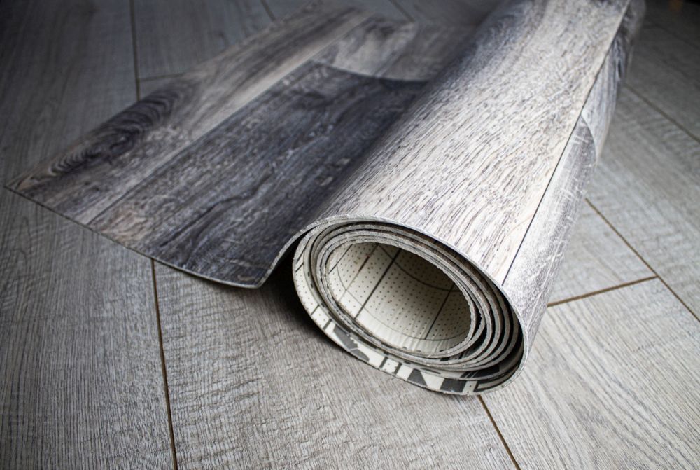 A Roll of Vinyl Flooring on A Wooden Floor — Geoff Thompson's Independent Flooring Centre In Port Macquarie, NSW
