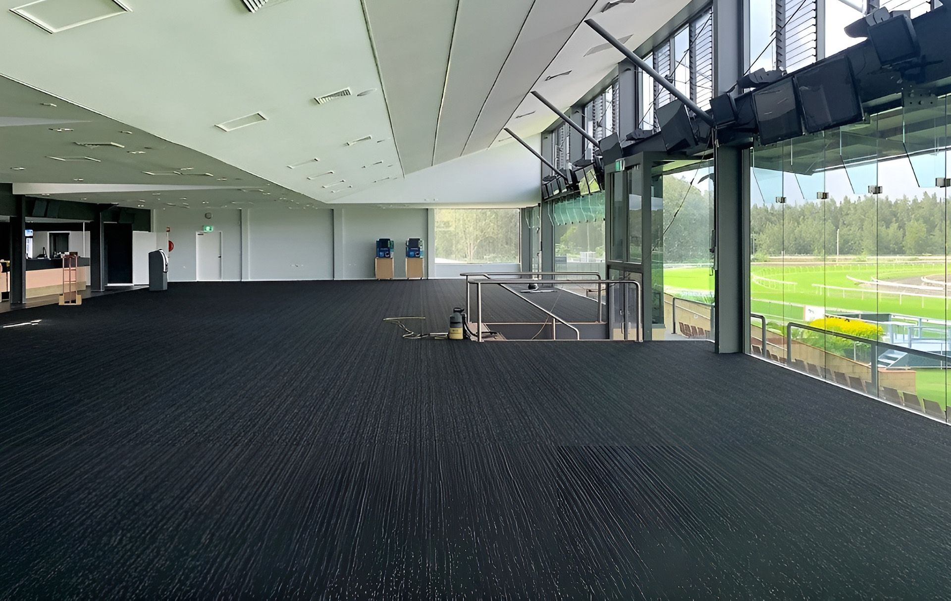 Empty Indoor with Black Carpet and Glass Window — Geoff Thompson's Independent Flooring Centre In Port Macquarie, NSW Empty Indoor with Black Carpet and Glass Window — Geoff Thompson's Independent Flooring Centre In Port Macquarie, NSW