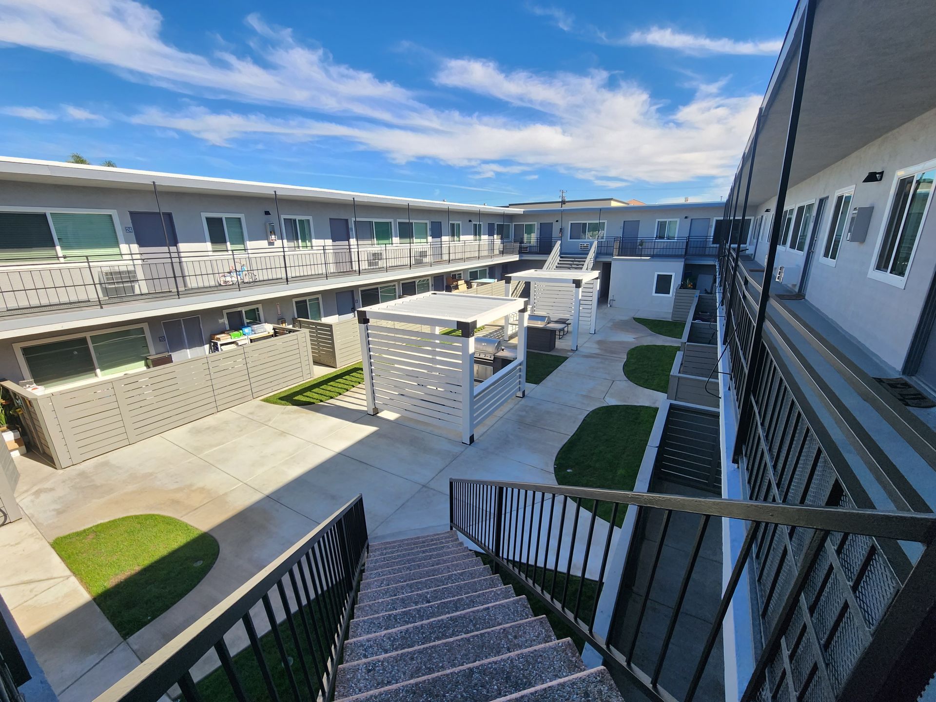 Photo showing an apartment complex courtyard from the upstairs point of view