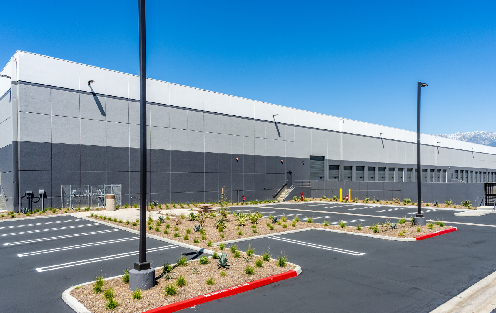 Photo showing the parking lot and length of a warehouse