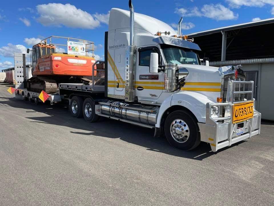 Semi Truck is Carrying a Large Excavator on a Trailer — Transforce in Wellington, NSW