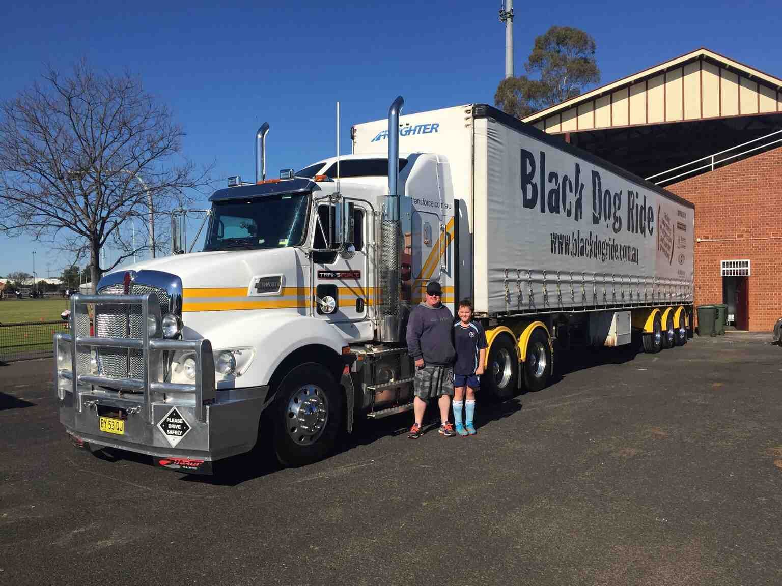 Two People Are Standing in Front of a Truck That Says Black Dog Vice — Transforce in Mudgee, NSW