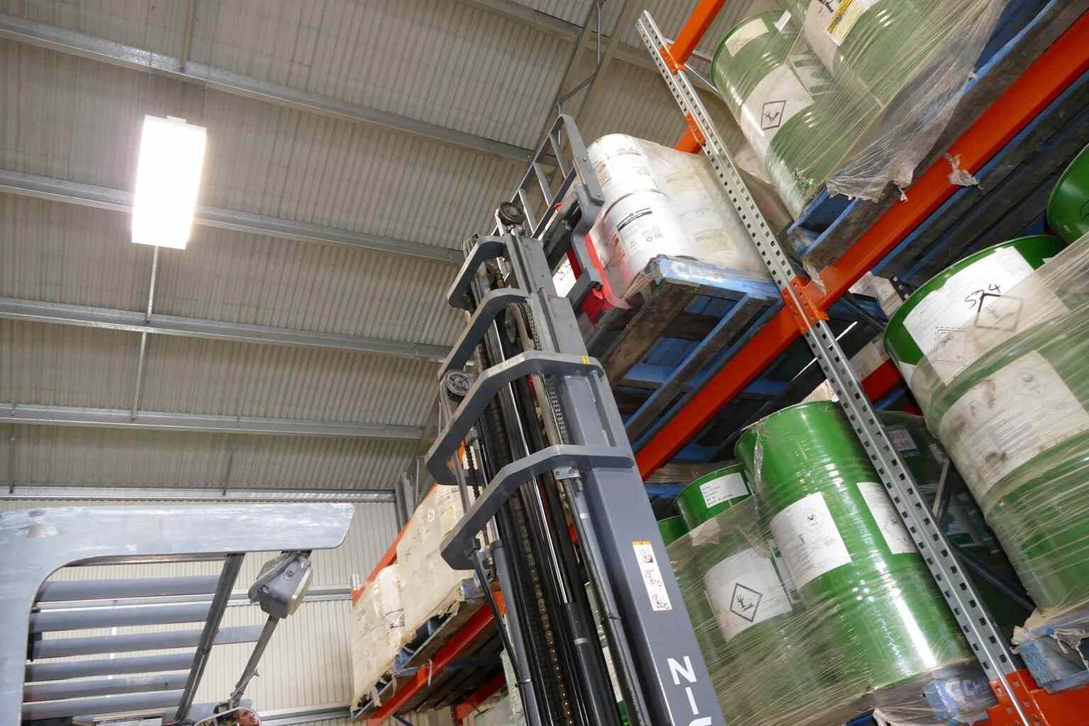 Forklift is in a Warehouse Filled With Lots of Barrels — Transforce in Parkes, NSW