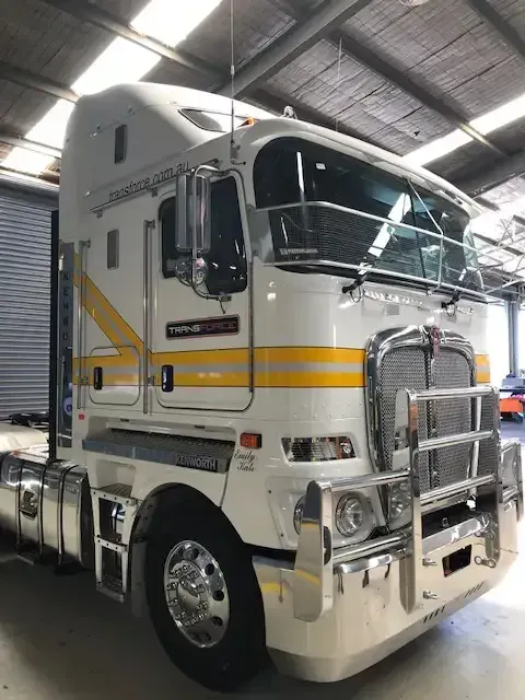 White Semi Truck With Yellow Stripes is Parked in a Warehouse — Transforce in Broken Hill, NSW