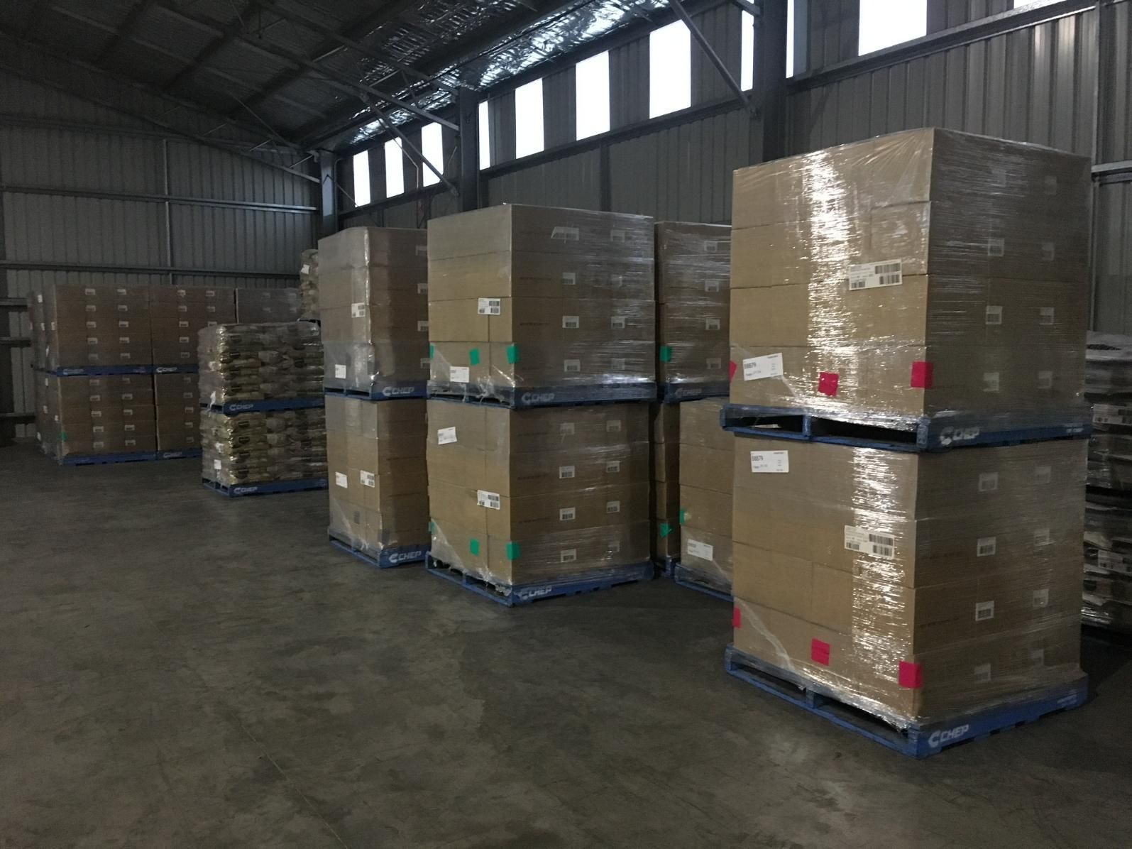 Warehouse Filled With Lots of Cardboard Boxes on Pallets — Transforce in Parkes, NSW