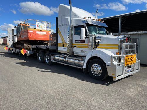 Semi Truck is Carrying a Large Excavator on a Trailer — Transforce in Gilgandra, NSW