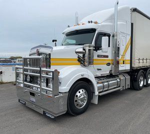 White Semi Truck With a Yellow Stripe on the Side is Parked on the Side of the Road — Transforce in Cobar, NSW