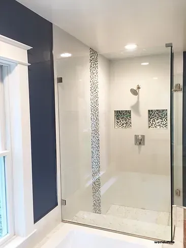 A bathroom with a tub and a shower with a glass door.