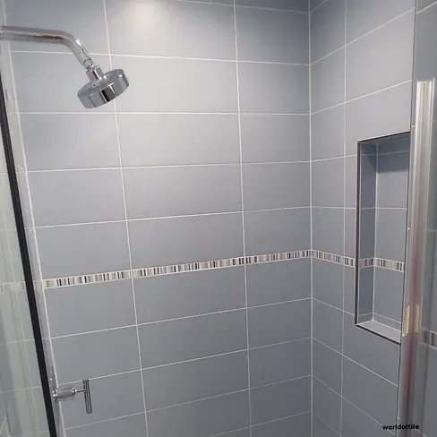 A shower with a shower head and a glass door.