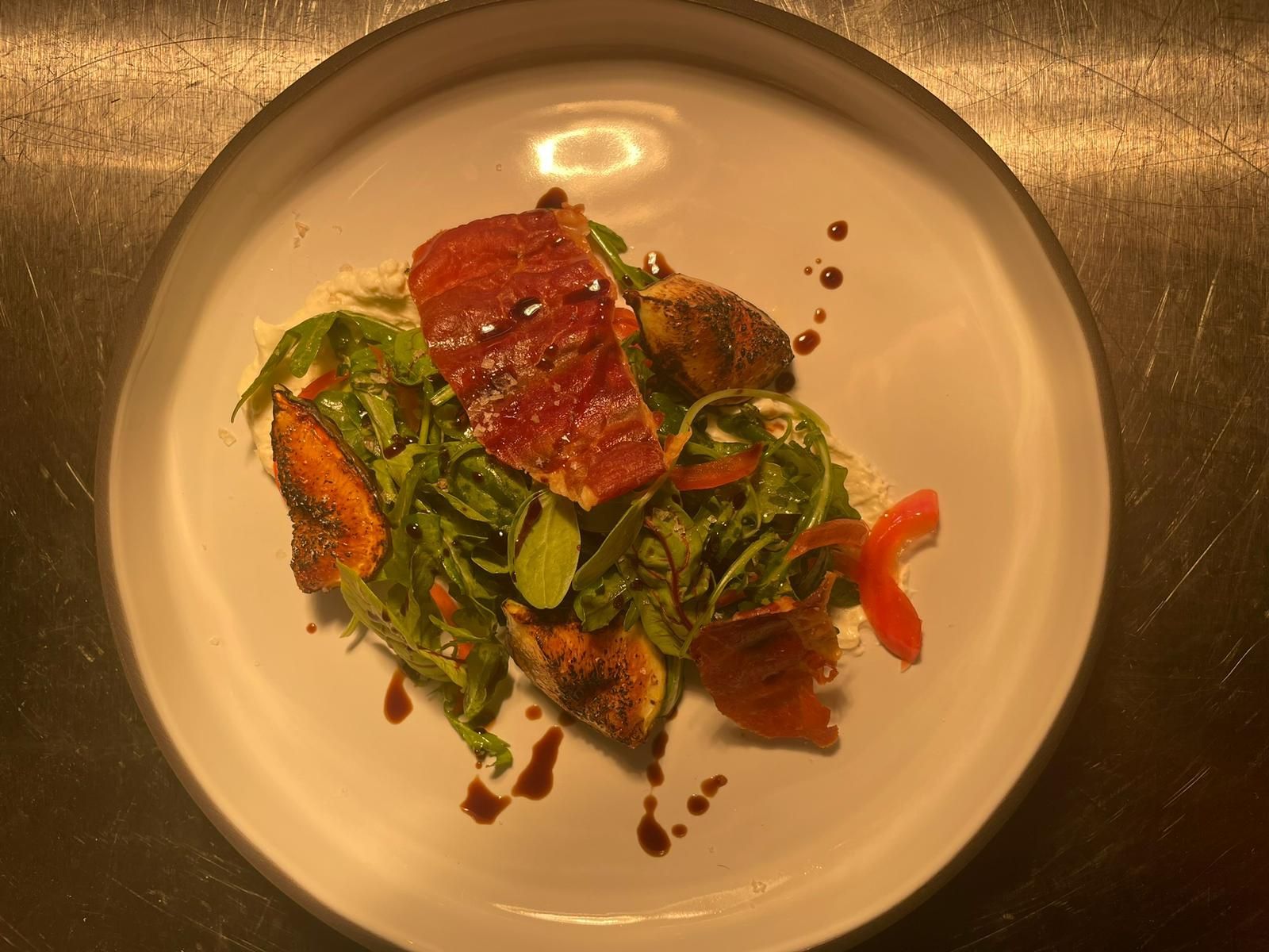 A plate of food with meat and vegetables on a table